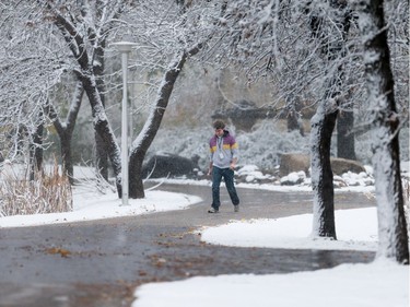 A student walks through the snow at the University of Saskatchewan in Saskatoon on October 5, 2016.