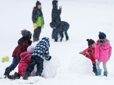 Brevoort Park elementary school children play in this year's first snowfall at recess in Saskatoon on October 5, 2016.