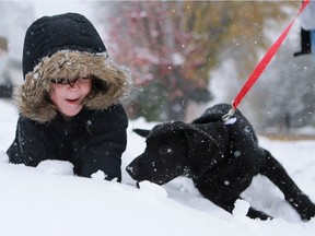 SASKATOON, SK - October 5, 2016 - Roberta Vazquez and her two sons Dominick and Luca walk their new puppy River home in the snow after adopting him from New Hope Dog rescue in Saskatoon on October 5, 2016. (Michelle Berg / Saskatoon StarPhoenix)