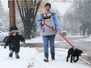 Roberta Vazquez and her two sons Dominick and Luca walk their new puppy River home in the snow after adopting him from New Hope Dog Rescue in Saskatoon on October 5, 2016.
