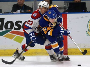 Saskatoon Blades'  Michael Farren gets bumped by Edmonton Oil Kings' Colton Kehler during first period action at SaskTel Centre in Saskatoon on October 9, 2016.