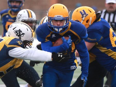 Saskatoon Hilltops' Adam Machart protects the ball during their game against the Edmonton Wildcats at SMF Field at Gordie Howe Bowl in Saskatoon on October 9, 2016.