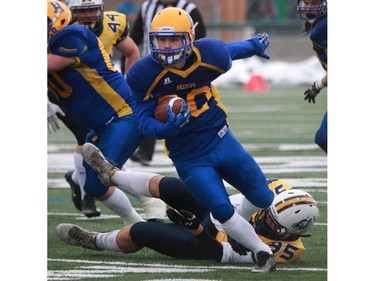 Saskatoon Hilltops' Adam Machart dodges a tackle during their game against the Edmonton Wildcats at SMF Field at Gordie Howe Bowl in Saskatoon on October 9, 2016.