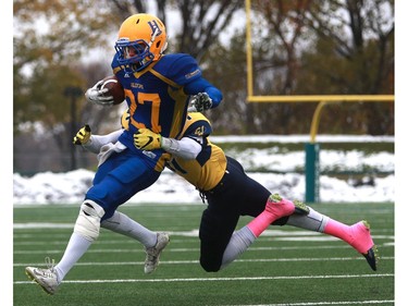 Saskatoon Hilltops' Des Vessey is tackled during their game against the Edmonton Wildcats at SMF Field at Gordie Howe Bowl in Saskatoon on October 9, 2016.