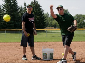 Team Sask coach Dave McCullough, left, with his pitcher son Darren as they prepare Monday, July 08, 2013 at Glen Reeves fields  for a softball championship this week .