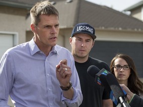 Saskatoon Mayoral candidate Charlie Clark, left, addresses a news conference hosted at the residence of Nick and Melissa Racine (right) , Monday, October 03, 2016.