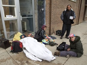 People try to stay warm on the sidewalk outside The Lighthouse.