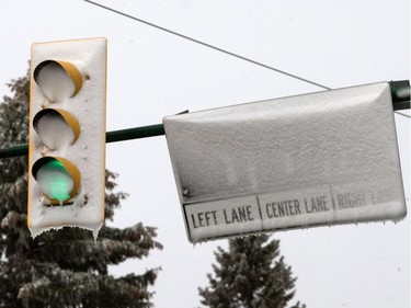 A heavy, wet snow from a major weather system  left Saskatoon residents shovelling and driving in slippery conditions, October 5, 2016.  Intermittent power outages affected traffic lights and created backlogs and also obscured road signage as here at Preston Avenue and 14th Street.