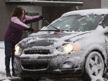 A heavy, wet snow from a major weather system left Saskatoon residents like Lauren Vaillant cleaning their cars and driving in slippery conditions, October 5, 2016.