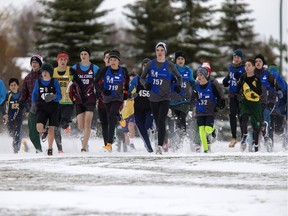 Toques and mitts were the norm as Midget boys competitors start their cross country race in the snow at Lakewood Park during the city championships, Tuesday, October 11, 2016.