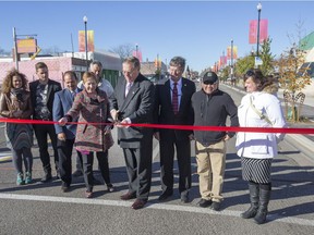Dignitaries including mayor Don Atchison (centre), Riversdale BID Executive Director Randy Pshebylo, councillor Pat Lorje and city planning director Alan Wallace cut the tape to officially mark the completion of the 20th Street West Streetscape Improvement Project in 2015.