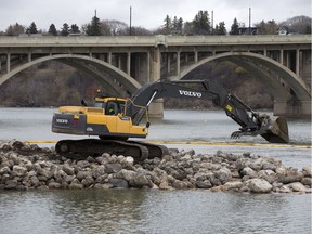 Work continues on both a new span of the traffic bridge and building a stone jetty to the remaining old span, Tuesday, October 18, 2016.