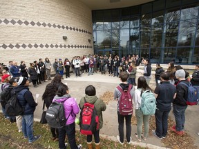 People attend a candlelight vigil outside the Gordon Oakes Red Bear Student Centre on the University of Saskatchewan campus Thursday to support those affected by the tragedies of youth suicides in northern Saskatchewan.