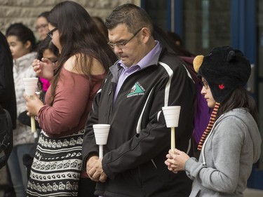 People attend a candlelight vigil outside the Gordon Oakes Red Bear Student Centre on the University of Saskatchewan campus to support those affected by the tragedies of youth suicides in northern Saskatchewan, October 20, 2016.