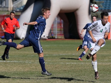 Tyler Redl of the University of Saskatchewan Huskies (R) tangles with Daniel Harrison of the Mount Royal University Cougars in action at PotashCorp Park on campus, October 21, 2016.