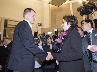 Newly elected mayor Charlie Clark shakes hands with defeated mayoral candidate Kelley Moore at City Hall in Saskatoon, October 26, 2016.