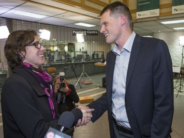 Kelley Moore shakes hands with Charlie Clark at City Hall following the civic election, October 26, 2016.