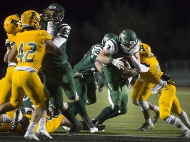 U of S Huskies' Colton Klassen (R) leaps the ball in for a touchdown with blocking from teammate Nick Summach during CIS football action against the University of Alberta Golden Bears at Griffiths Stadium in Saskatoon, October 28, 2016.