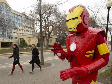 The Denny Carr memorial statue at the bottom of the University Bridge was drawing stares as it was dressed for Halloween in an annual tradition, this time as Iron Man, October 31, 2016.