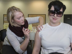 Kristen Thoms, right, gets a free flu shot  from nurse Sarah Osika at a clinic at Station 20, Monday, October 31, 2016.  (GREG PENDER/STAR PHOENIX)