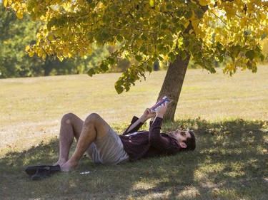 Alexis Combe enjoys some reading in the shade of Victoria Park, September 15, 2016.