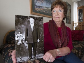 Patricia Mialkowsky  holds a photograph of her father, Wasyl Puzniak, in her home, Friday, September 16, 2016. (GREG PENDER/STAR PHOENIX)