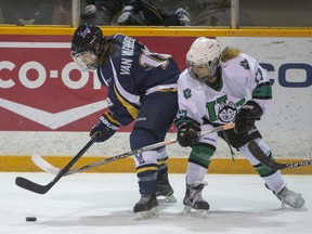 The University of Saskatchewan Huskies forward Kaitlin Willoughby battles for the puck with University of Lethbridge Pronghorns forward Tricia Van Vaerenbergh in CIS women's hockey action at Rutherford Rink on Saturday, January 9th, 2016.