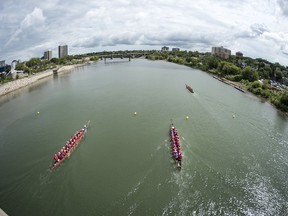 Competitors paddle their dragon boat in a race during the FMG's Saskatoon Dragon Boat Festival along the South Saskatchewan River near Rotary Park in Saskatoon.