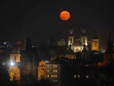The supermoon rises above the Old Town square in Prague, November 14, 2016. The unusually big and bright moon appeared at its most impressive as night fell over Asia, but astronomy enthusiasts will be able to see Earth's satellite loom large anywhere in the world shortly after sunset.