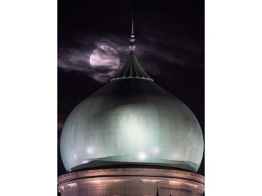 A supermoon is seen past the dome of the Prime Minister's Office complex in Putrajaya on November 14, 2016. Skygazers headed to high-rise buildings, ancient forts and beaches on November 14 to witness the closest "supermoon" to Earth in almost seven decades, hoping for dramatic photos and spectacular surf. The moon will be the closest to Earth since 1948 at a distance of 356,509 kilometres, creating what NASA described as "an extra-supermoon."