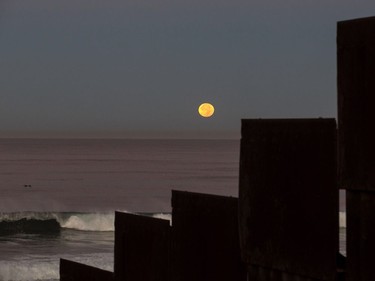 A supermoon sets behind the U.S.-Mexico border fence during its closest orbit to the Earth since 1948 on November 14, 2016 in Tijuana, Mexico.