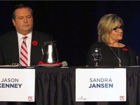 Progressive Conservative candidates Jason Kenney, a former Conservative MP, and Sandra Jansen sit next to each other during the Alberta Progressive Conservative party leadership forum in Red Deer, Alta. on Saturday, Nov. 5, 2016. The only two female candidates in the Alberta Progressive Conservative leadership race are calling it quits, one of them citing Trump-style intimidation tactics in the campaign.