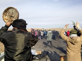 Protesters against the Dakota Access oil Pipeline congregate Monday on a long-closed bridge on a state highway near their camp in North Dakota. The bridge was the site of the latest skirmish between protesters and police.