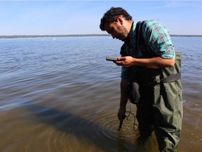 Ricardo Segovia of E-Tech International conducts sediment tests on the North Saskatchewan River following the Husky Energy Inc. pipeline spill in July 2016.