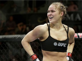 FILE - In this Feb. 22, 2014, file photo, Ronda Rousey looks around after defeating Sara McMann in a UFC 170 mixed martial arts women's bantamweight title bout in Las Vegas