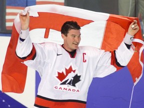 Team Canada captain Mario Lemieux wraps himself in the Canadian Flag after the team won gold in men's hockey at the Salt Lake City Olympics. Canada defeated the United States 5-2 to take the gold for the first time in 50 years.