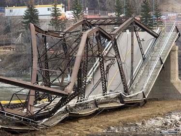 The remaining traffic bridge pillar on the west side of the city is being chipped away and finally dropping the remaining span left of the structure to the ground, November 17, 2016.