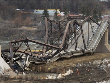 The remaining traffic bridge pillar on the west side of the city is being chipped away and finally dropping the remaining span left of the structure to the ground, November 17, 2016.