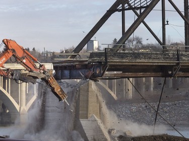 The remaining traffic bridge pillar on the west side of the city is being chipped away and finally dropping the remaining span left of the structure to the ground, November 17, 2016.