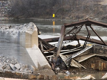 The remaining traffic bridge pillar on the west side of the city is being chipped away and finally dropping the remaining span left of the structure to the ground, November 17, 2016.