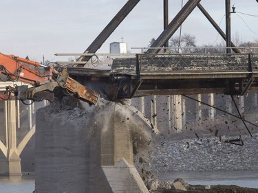 The remaining traffic bridge pillar on the west side of the city is being chipped away and finally dropping the remaining span left of the structure to the ground, November 17, 2016.