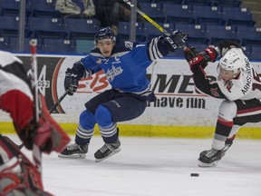 Saskatoon Blades captain Wyatt Sloboshan makes his own path towards the Moose Jaw Warriors goalie, moving the stick at Brandon Armstrong out of the way in first-period WHL action, Nov. 17, 2016.