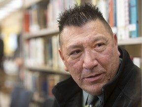 IRS survivor Kelly Bitternose speaks to a reporter at the opening of the Reconciliation Reading area at the Frances Morrison Central Library. (GordWaldner/Saskatoon StarPhoenix)