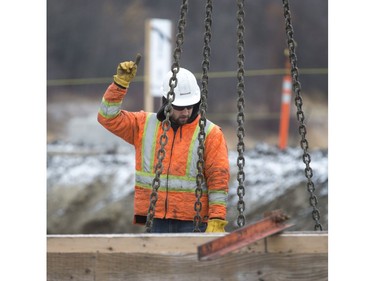 Crane operator's partner at the North Commuter Bridge construction site during a media tour showing the progress on the westside pillars, with the second close to completion, November 23, 2016.