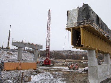 Pilings being pounded in the background at the west entrance to the North Commuter Bridge at the construction site during a media tour showing the progress on the westside pillars, with the second close to completion, November 23, 2016.