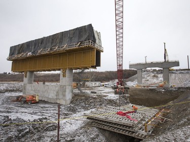 Pilings being pounded in the background at the west entrance to the North Commuter Bridge at the construction site during a media tour showing the progress on the westside pillars, with the second close to completion, November 23, 2016.