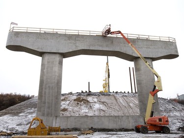 Pilings being pounded in the background at the west entrance to the North Commuter Bridge at the construction site during a media tour showing the progress on the westside pillars, with the second close to completion, November 23, 2016.