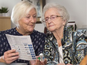 Gail LaPointe with her mother Sheila look through Sheila's medications. (GordWaldner/Saskatoon StarPhoenix)
