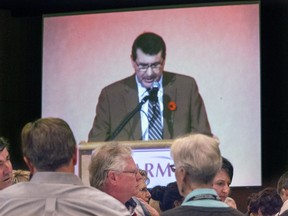 Delegates at SARM's midterm conference watch a television projection of SARM President Ray Orb during his opening address.