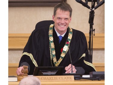 Saskatoon's new mayor Charlie Clark chuckles while tapping the gavel a couple times in fun after he and the newly elected city councillors were sworn in, October 31, 2016.